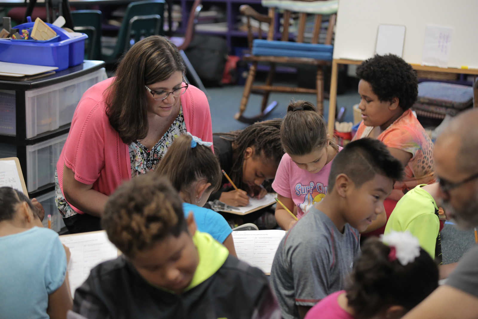 female SPC graduate teaching small students in a classroom