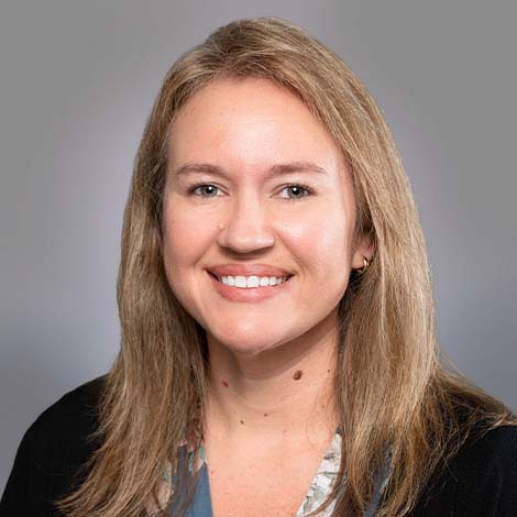 A portrait of Jessica Curtis wearing a black blouse.