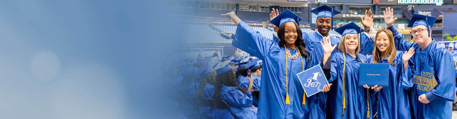 graduates celebrating wearing cap and gown