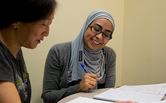 a student and her tutor reviewing course work