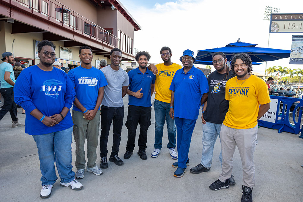 A group of 8 men, wearing their SPC gear, posing for a photo at the 2025 SPC Day Clearwater Threshers game.