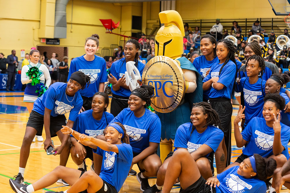 The SPC women's basketball team posing for a photo with Titus