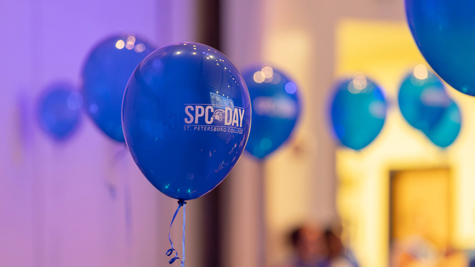image of blue balloons with the words SPC Day written in white