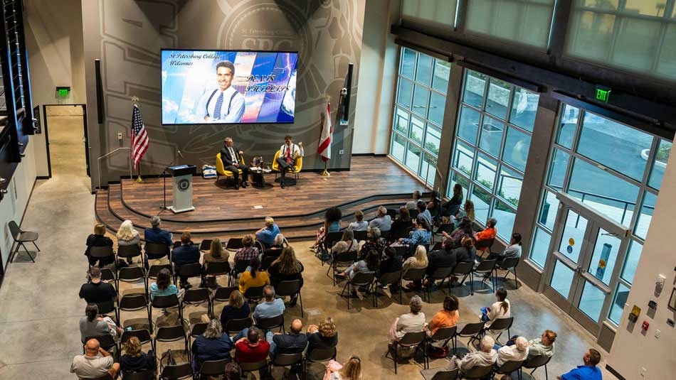 groups of attendess listening to guest speaker Denis Phillips