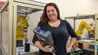 a young lady wearing a black long sleeve shirt holding a manufacturing controller