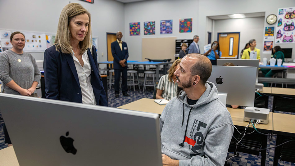 Florida Department of Education’s Chancellor Kathy Hebda visits with a student in a classroom