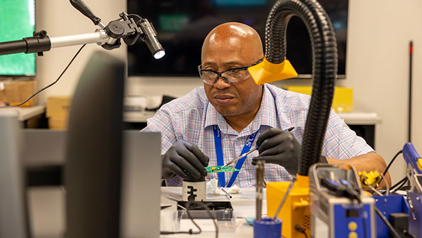 Man working on a soldering station