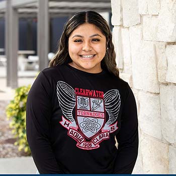 Edith Palma-Hernandez posing at the Clearwater Campus, wearing a black Clearwater High School sweatshirt.