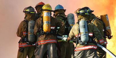 group of firefighters training on a burning buidling