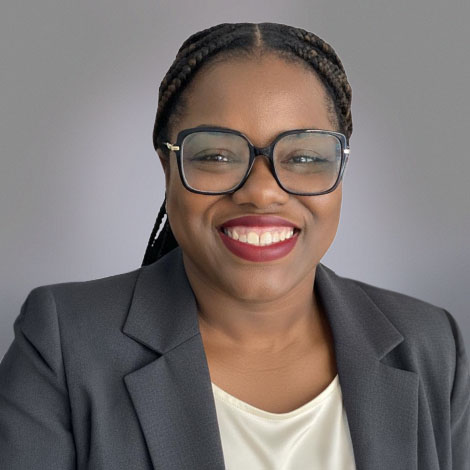 Kiani Bowman portrait wearing a gray suit jacket with white top