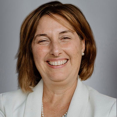 A portrait of Danielle Marolf, wearing a white blazer.