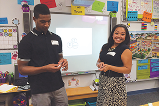 two people standing in an elementary school classroom