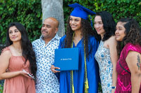 SPC graduate taking photos with her family