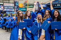 group of female SPC graduate with arms in the air celebrating