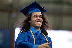 man wearing blue cap and gown