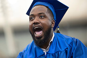 graduate wearing cap and gown