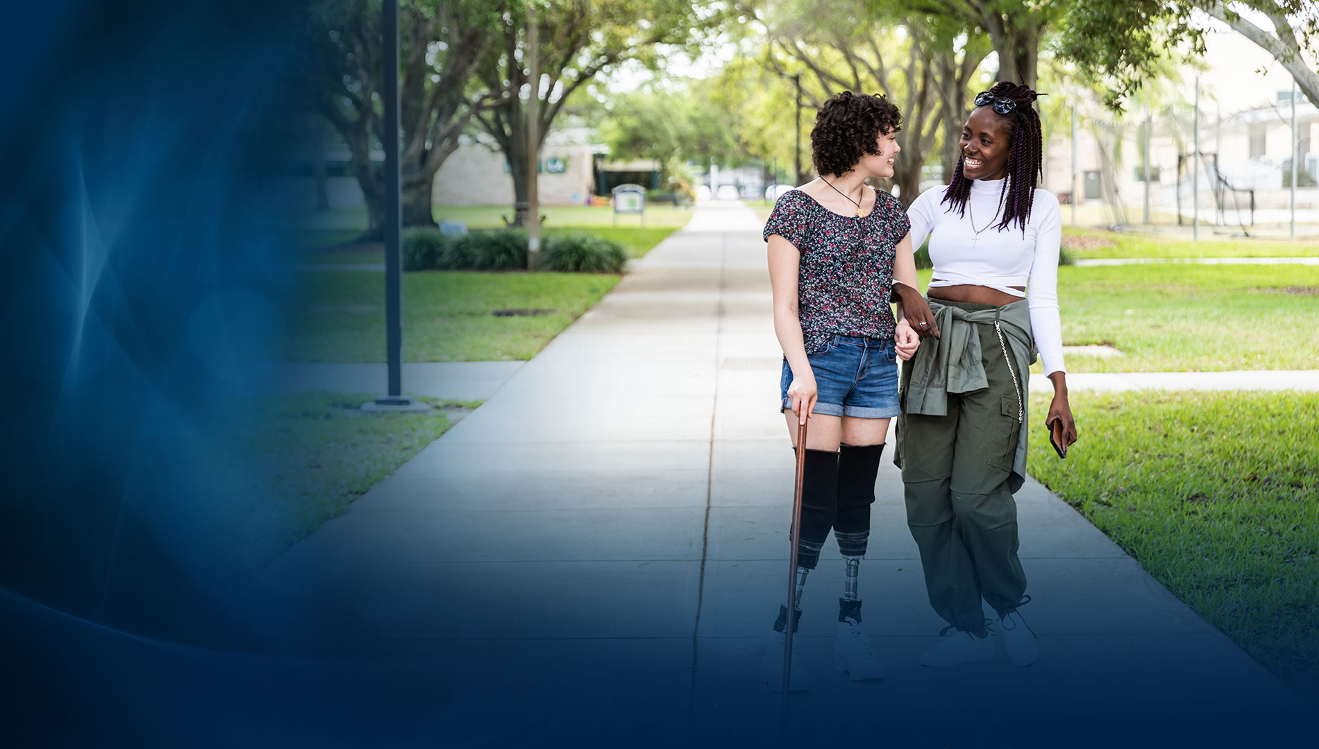 two female SPC students walking on a campus smiling