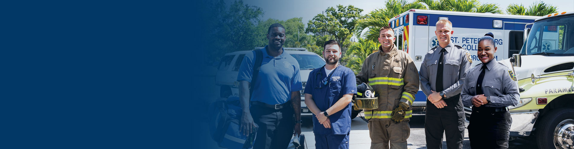 First responders, EMT, nurse, firefighter, and two police officers, standing in front of their vehicles.