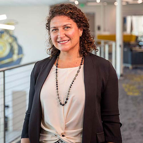A portrait of Luisa Shamas on an SPC campus, wearing a brown blazer and tan top.
