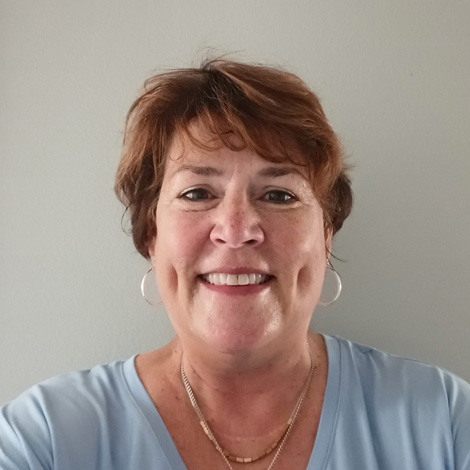 portrait of Rita Applegate wearing a light blue shirt and necklace