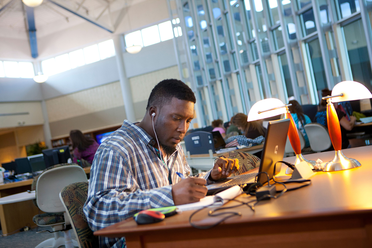 a student sitting at a table, studying