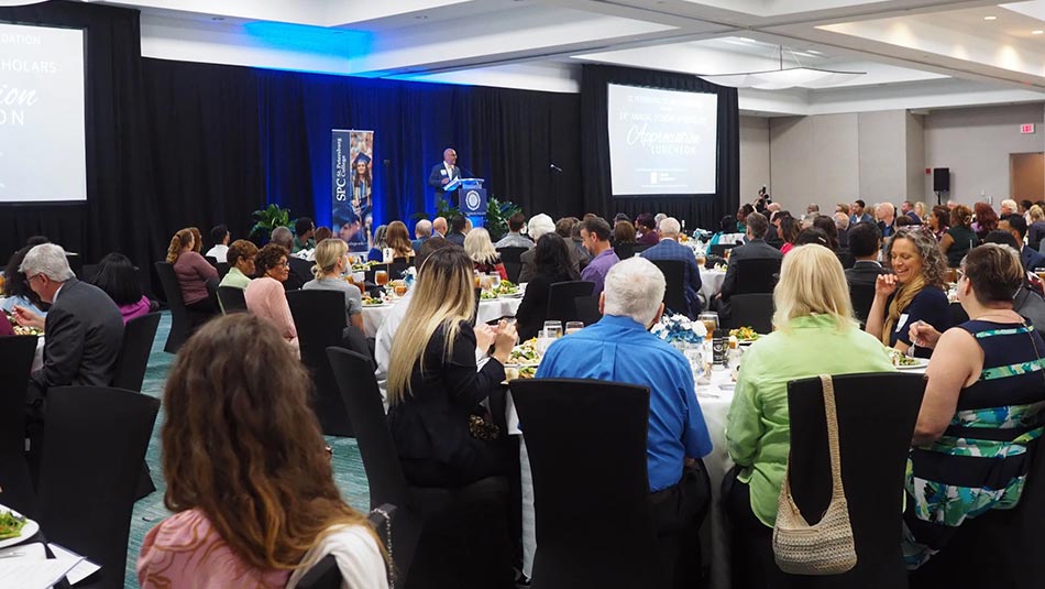 group of donors celebrating at a luncheon with the scholars they provided schoalships to
