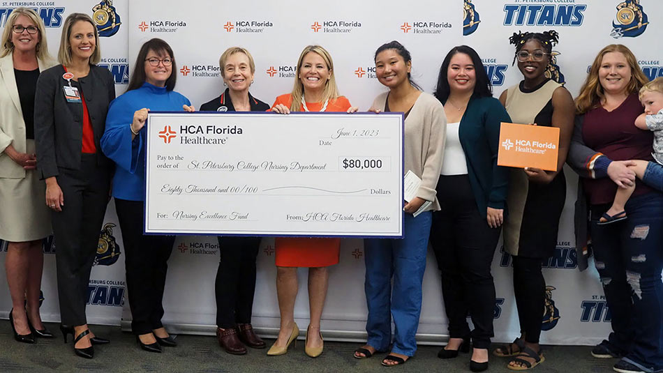 Group of people holding donation check