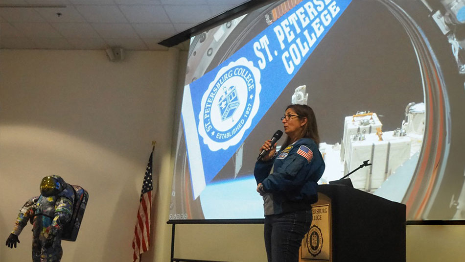 SPC alumni NIcole Scott speaking on a stage