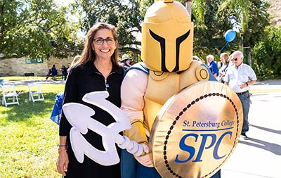 SPC Alumna Nicole Stott posing with Titus, the Titan mascot at SPC Day