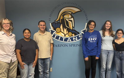 SPC collegiate high school students lined up in front of a blue wall with the SPC logo