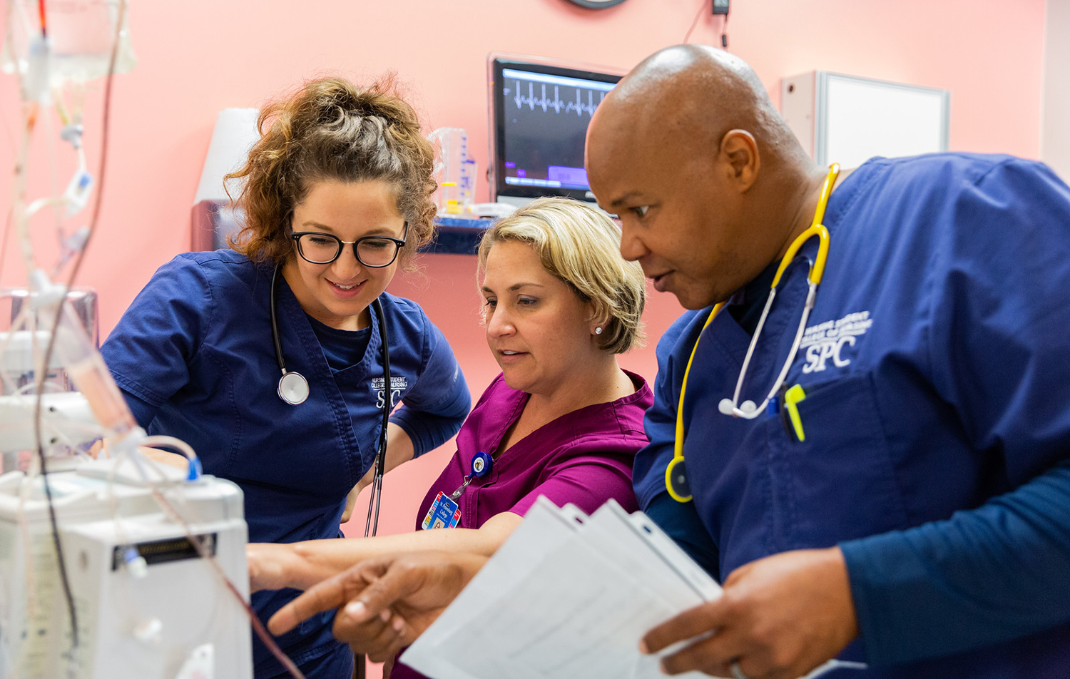 nursing students gathered at a machine