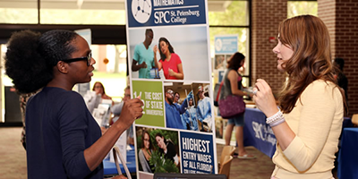 two women talking at an SPC Alumni event