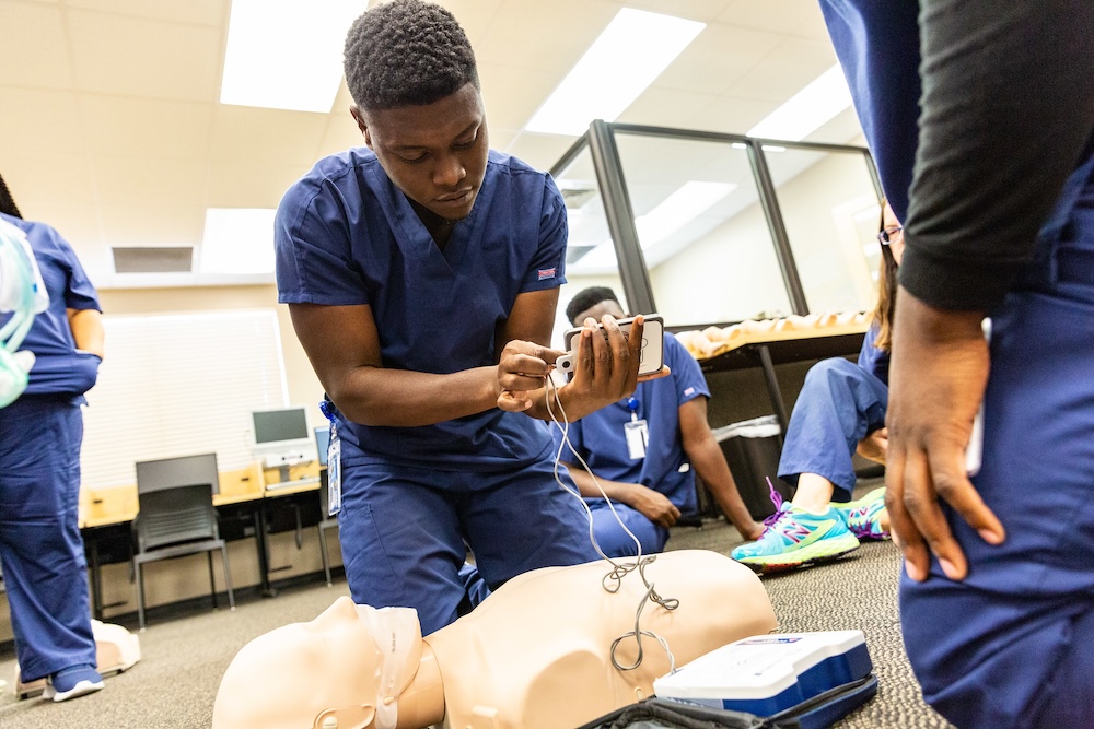 male health students practicing CPR