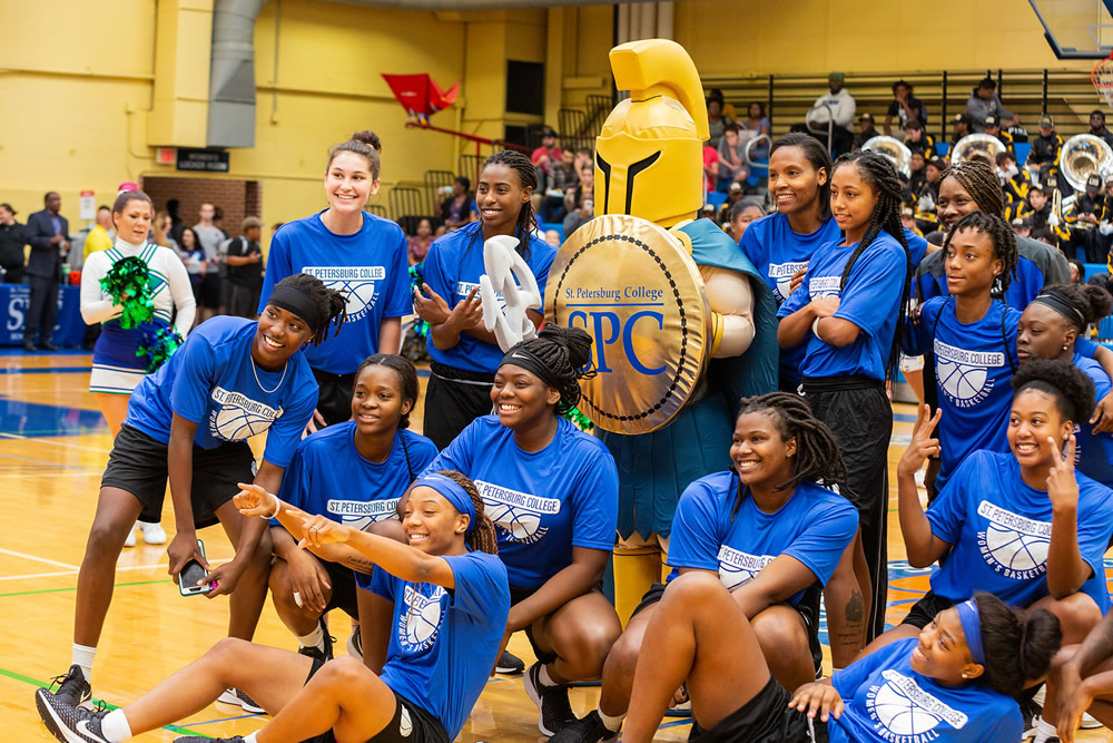 SPC student group of SPC student sports fans posing with Titus the Titans mascot in the gym on the St. Petersburg Gibbs Campus