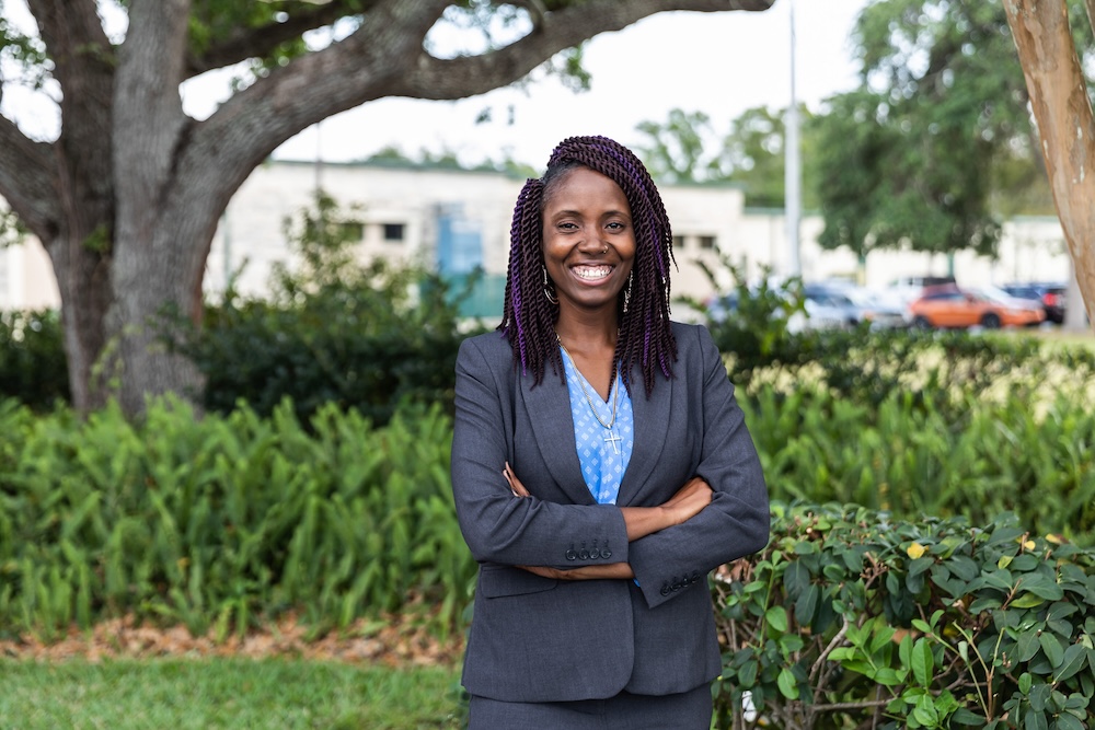 SPC student female in a grey business suit with her arms folded standing outside on the Clearwater Campus