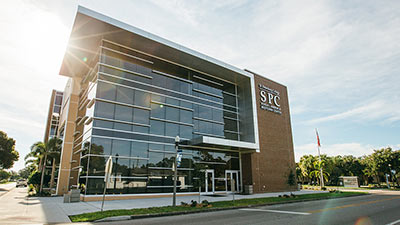 Douglas L. Jamerson, Jr. Midtown Center tan and glass building with the sun rising behind it