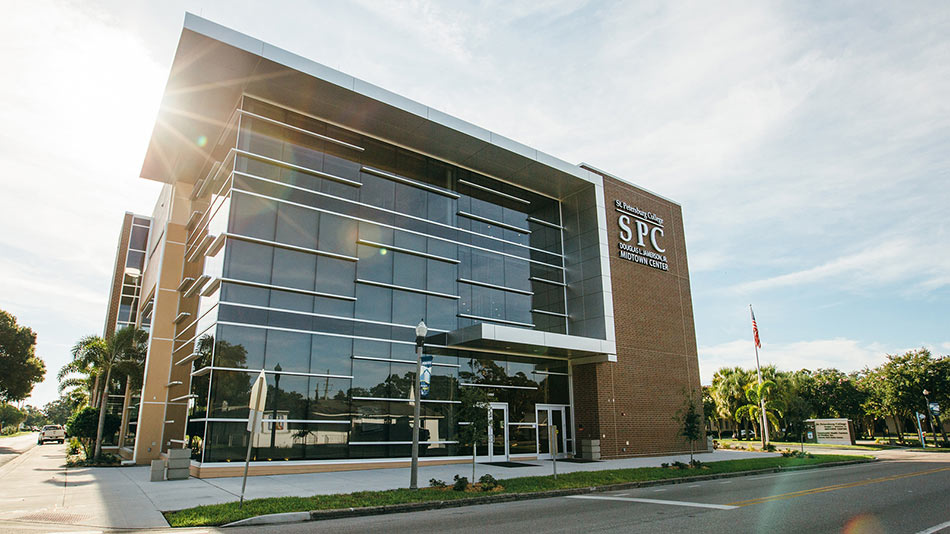 Douglas L. Jamerson, Jr. Midtown Center tan and glass building with the sun rising behind it