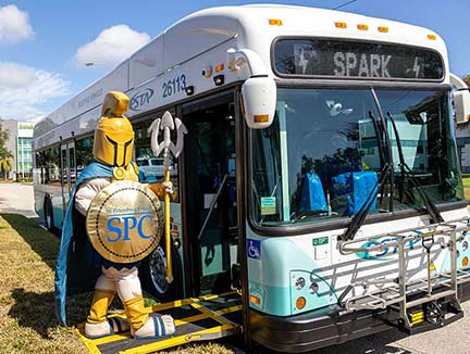 titus the titan mascot boarding a SPARK bus