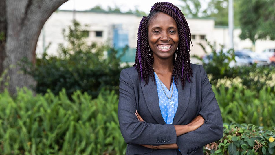 african american female student dressed in a gray business suit and blue shirt