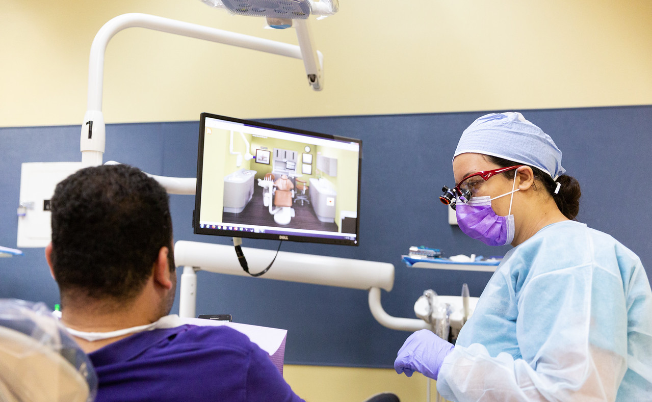 dental hygiene student with a patient in the dentist chair