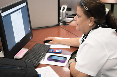 a student working on her computer in a classroom