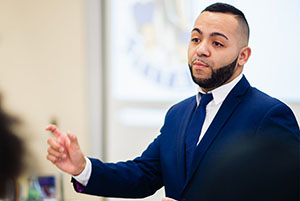 man on a business suit giving a presentation