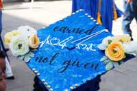SPC graduate decorated cap with flowers and text