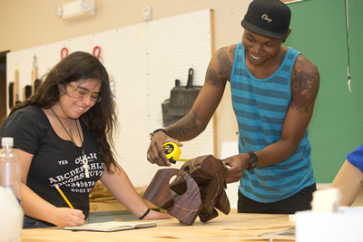 students laughing with each other in design class