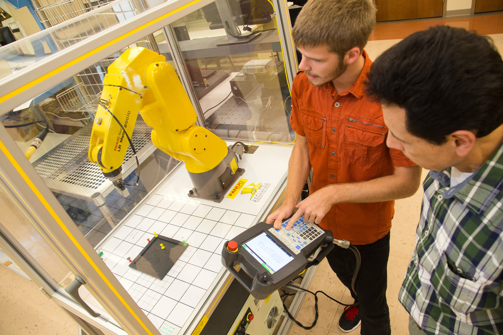 two male students using a 3D printer