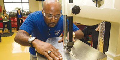 an SPC student operating a band saw