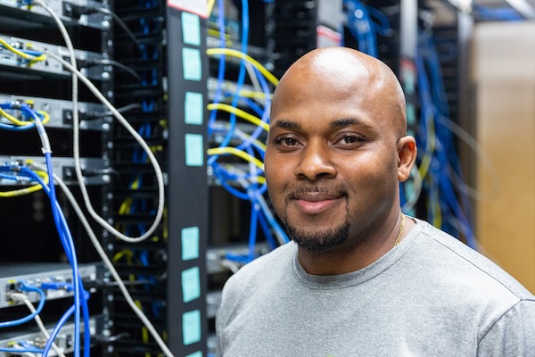 male student plugging into servers