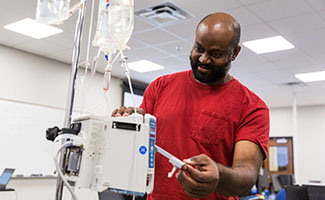 male student repairing medical equipment