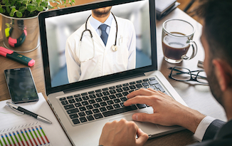 open laptop showing a medical doctor wearing a white coat