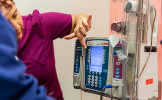 nurses looking at medical equipment